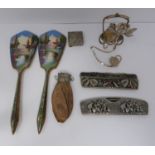 A collection of collactibles including, two enamel mirrors, two white metal combs, a leather coin