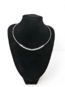 An 18ct white gold and diamond set collar necklace, double branched design, one polished one matt,