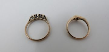 Two gold gemset rings, one cross-over design with a round brilliant diamond with an approximate