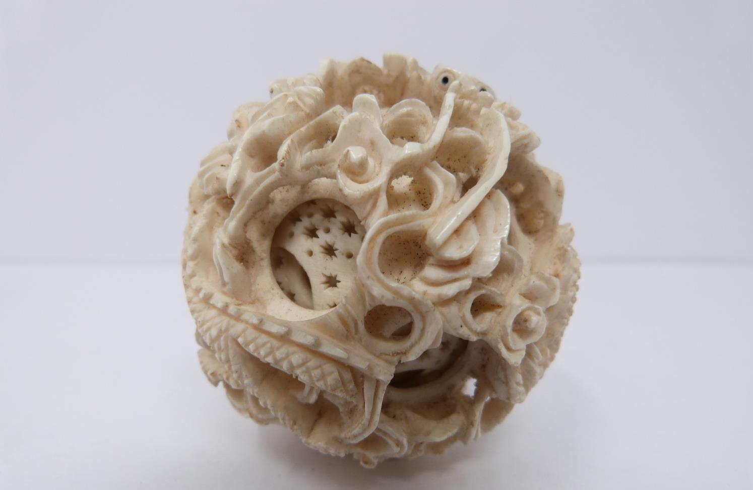 An early 20th century ivory puzzle ball and a small carved ivory and white metal burner, dragon - Image 7 of 7