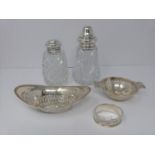 Two silver and cut glass sugar sifters, two silver pierced dishes and a silver engraved napkin ring,