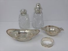 Two silver and cut glass sugar sifters, two silver pierced dishes and a silver engraved napkin ring,