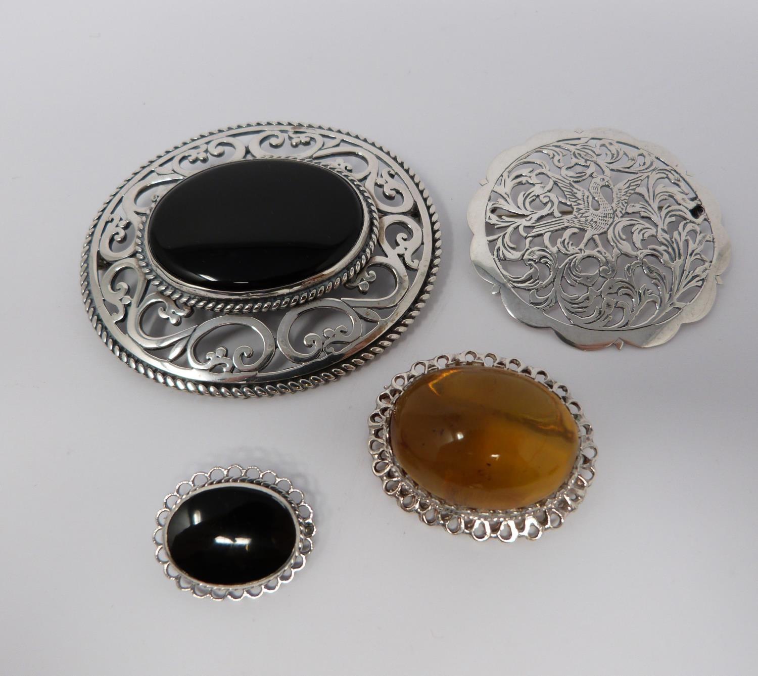 Large jet and hallmarked silver pierced brooch, with a pierced white metal brooch, small silver