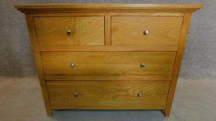 A contemporary oak chest of two short over two long drawers. H.93 W.116 D.48cm