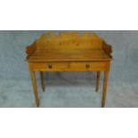 A Victorian pine washstand with raised shaped back and two frieze drawers on turned tapering
