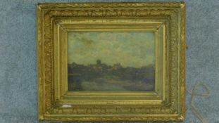 A 19th century gilt framed oil on canvas, A Norman church on the skyline in a village by an estuary,