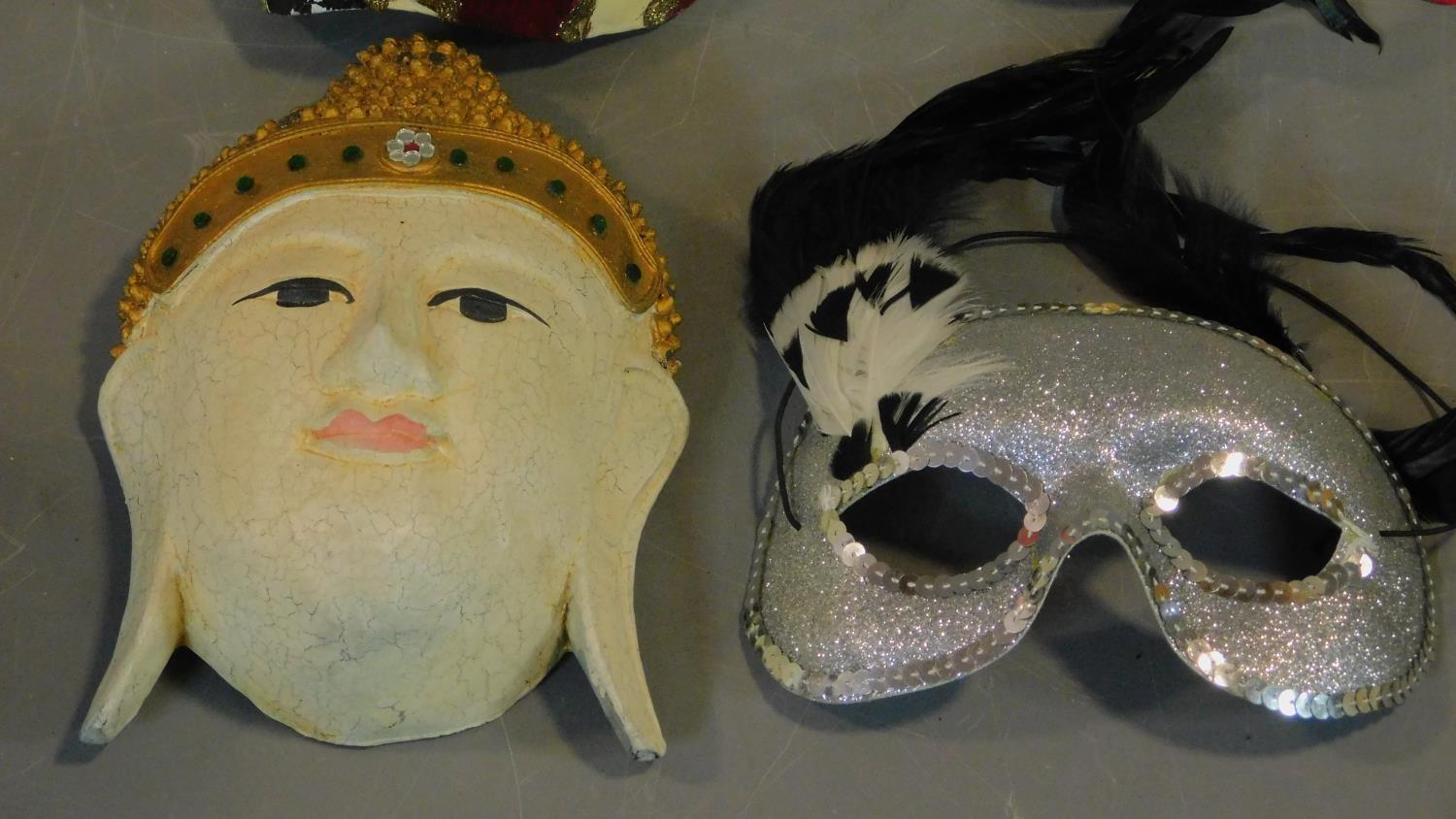 A collection of eight Venetian and other masks. - Image 3 of 4