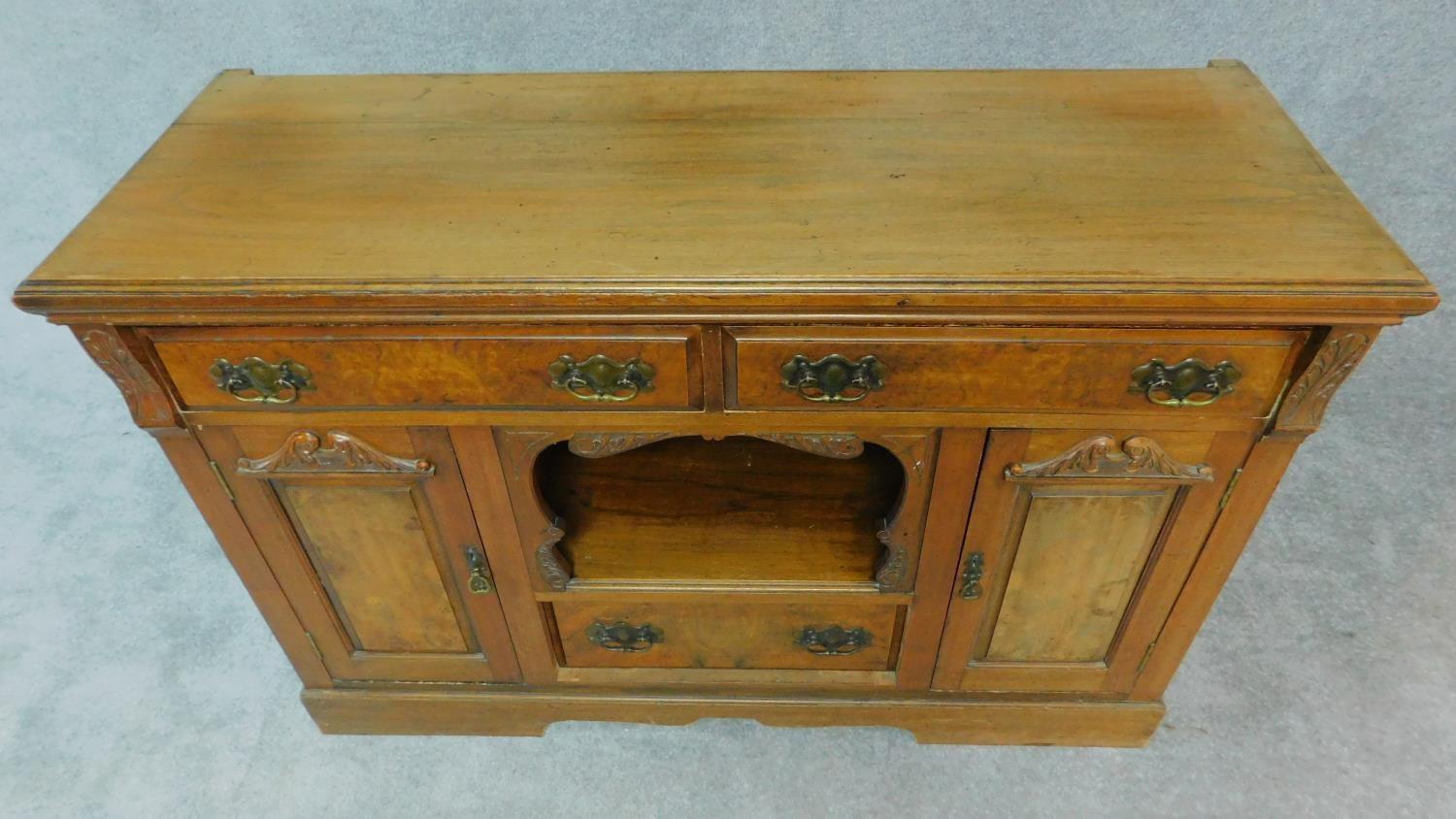 A late Victorian carved walnut sideboard fitted drawers and cupboards on bracket feet. H.94 W.137 - Image 3 of 8