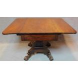 An early 19th century mahogany drop flap dining table fitted end drawer on quadruped platform base