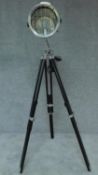 A chrome theatre spotlight on adjustable tripod base. H.153cm