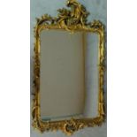 An elaborately carved giltwood rococo style wall mirror 156x85