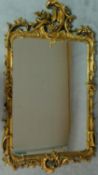 An elaborately carved giltwood rococo style wall mirror 156x85