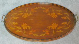 A late 19th century oval mahogany and marquetry inlaid tray with twin brass carrying handles. W.67