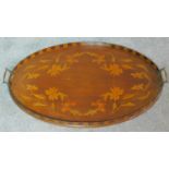 A late 19th century oval mahogany and marquetry inlaid tray with twin brass carrying handles. W.67