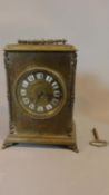 A late 19th century brass cased mantel clock H.23 W.17cm (with key and pendulum)