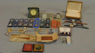 A miscellaneous collection of items, silver plated spoon collection, wristwatches, travel clocks and