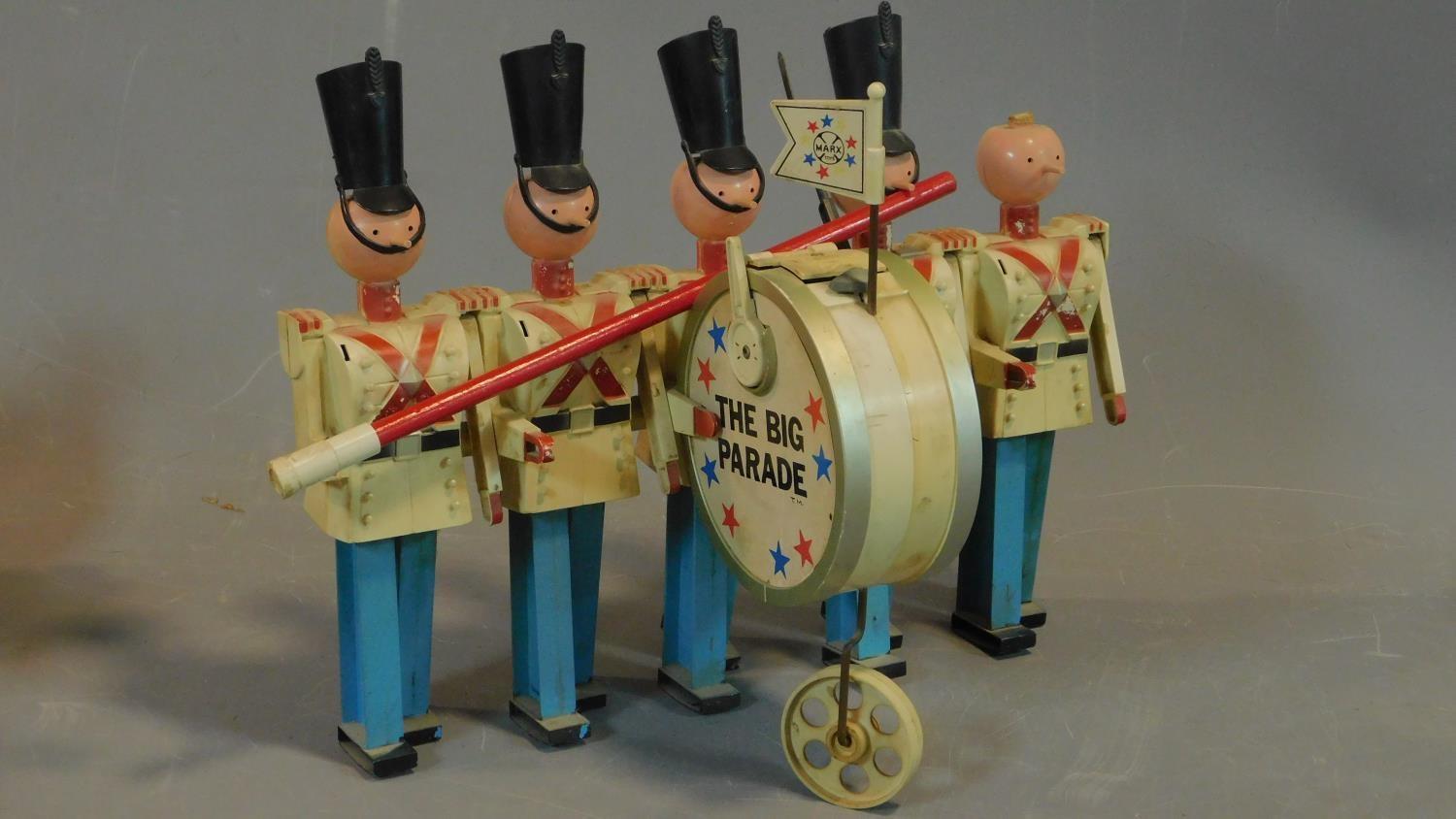 A toy model of a marching band and a tinplate vintage car. 21x25cm (car) - Image 2 of 5