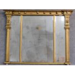 A Regency gilt triple section overmantel mirror with original bevelled plates flanked by reeded