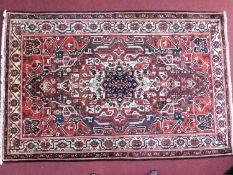 A North West Persian Malayer rug, central ivory medallion with repeating spandrels on a terracotta