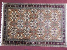 A Persian rug with repeating geometric motifs on a cream ground, within geometric borders 245x160cm