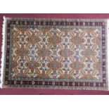 A Persian rug with repeating geometric motifs on a cream ground, within geometric borders 245x160cm