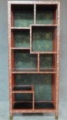 A Chinese red lacquered and mother of pearl inlaid open bookcase. H.166 W.71cm