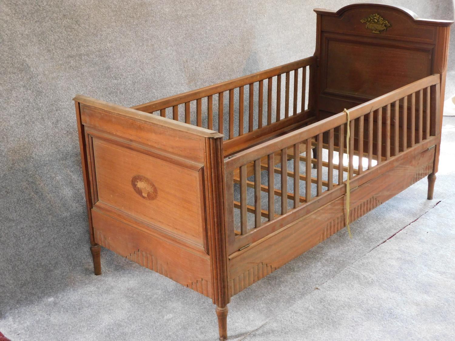 An early 20th century walnut child's bed with satinwood and ebony stringing and floral marquetry - Image 2 of 7