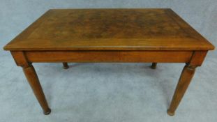 A late 19th century dining table with parquetry inlaid top on turned tapering supports. H.74 W.130