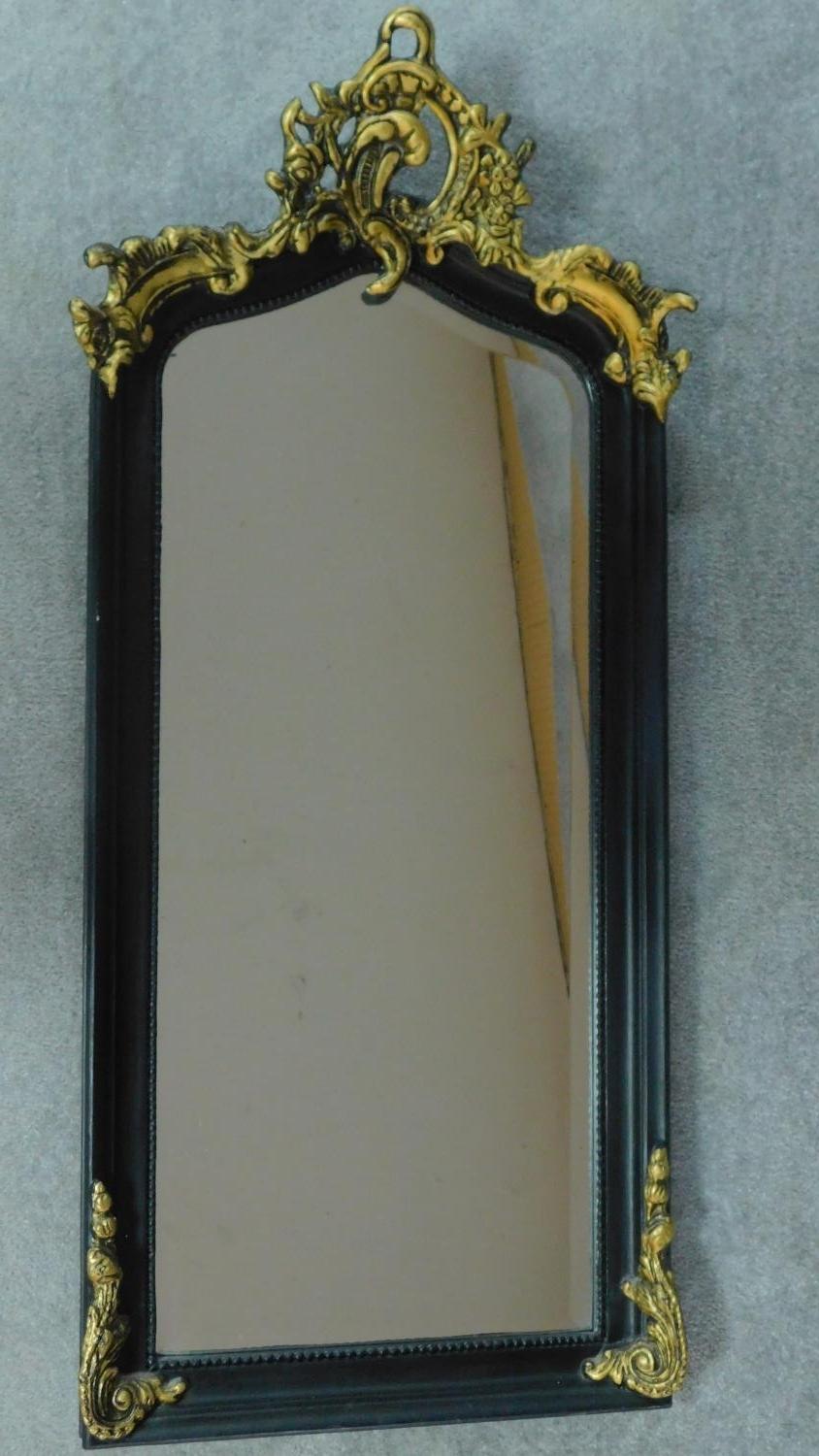 A rococo style gilt and ebonised pier mirror. 115x52cm