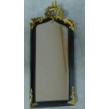 A rococo style gilt and ebonised pier mirror. 115x52cm