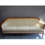 A mid 20th century Danish teak three seater sofa by Broderna Anderssons, makers label to