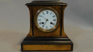 A 19th century walnut and ebonised mantel clock, circular enamel dial with Roman numerals with