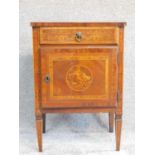A 19th century continental walnut and marquetry inlaid pot cupboard with frieze drawer above