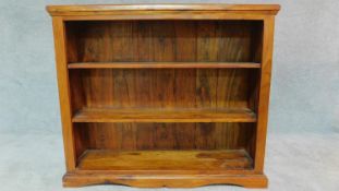 A teak open bookcase on plinth base. H.90 W.106 D.28cm