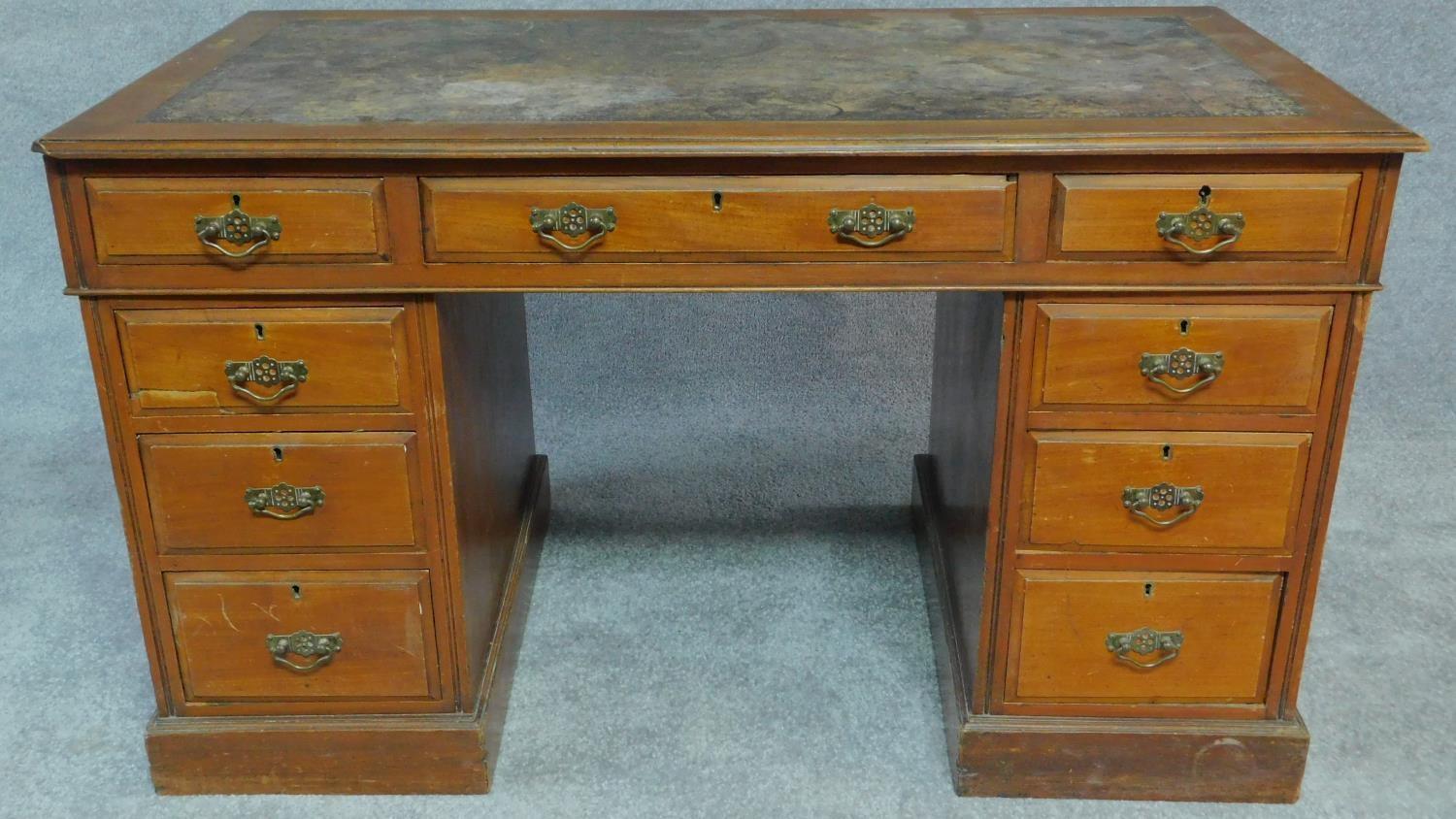 A late Victorian walnut three section pedestal desk with original inset leather top fitted