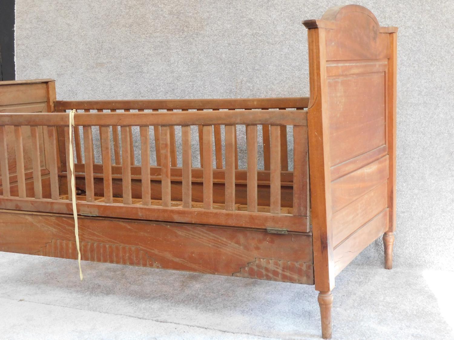 An early 20th century walnut child's bed with satinwood and ebony stringing and floral marquetry - Image 3 of 7