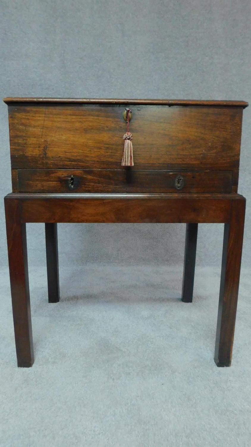 A Georgian mahogany box on stand with brass hinged lid, fitted two frieze drawers. H.76 W.46 D.75 (