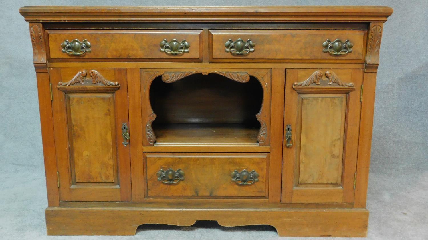 A late Victorian carved walnut sideboard fitted drawers and cupboards on bracket feet. H.94 W.137