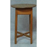 An antique oak circular top table on square stretchered supports. H.69cm