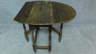 An antique country oak drop flap table. H.70cm (incomplete, for repair)