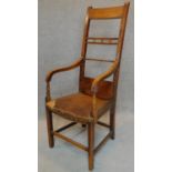 A 19th century country elm and yew armchair. H.124cm