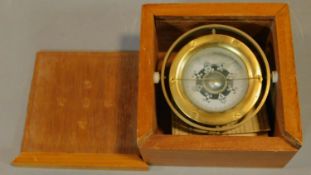 A boxed mariner's compass with Chinese astrological compass points. 13.cm x 13cm.