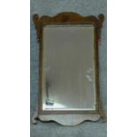 A Georgian shaped mahogany wall mirror with gilt slip and original bevelled plate. 76x47cm