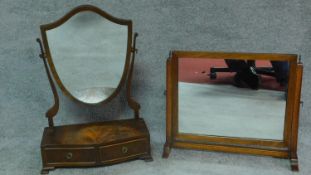 A Georgian style mahogany swing mirror with fitted base and a similar Edwardian oak mirror. H.64cm