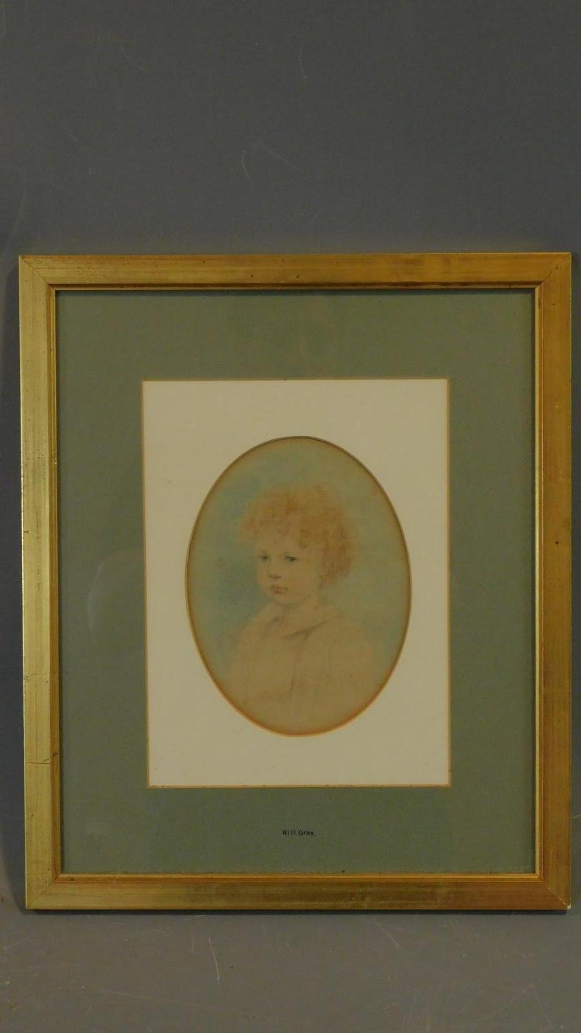 A gilt framed and glazed watercolour sketch of a young child set in oval mount. 43x36cm