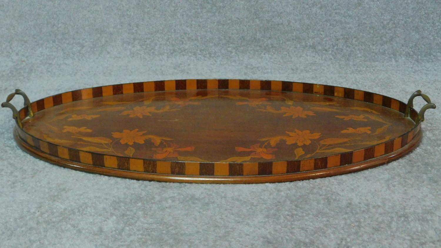 A late 19th century oval mahogany and marquetry inlaid tray with twin brass carrying handles. W.67 - Image 3 of 5