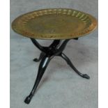 An Eastern polychrome brass tray on carved tripod stand. H.50 W.60 D.60