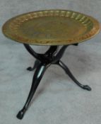 An Eastern polychrome brass tray on carved tripod stand. H.50 W.60 D.60