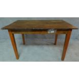 A country style planked top dining table on square tapering supports. H.78 W.127 D.81cm
