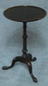 A 19th century mahogany wine table on tripod cabriole supports. H.65cm